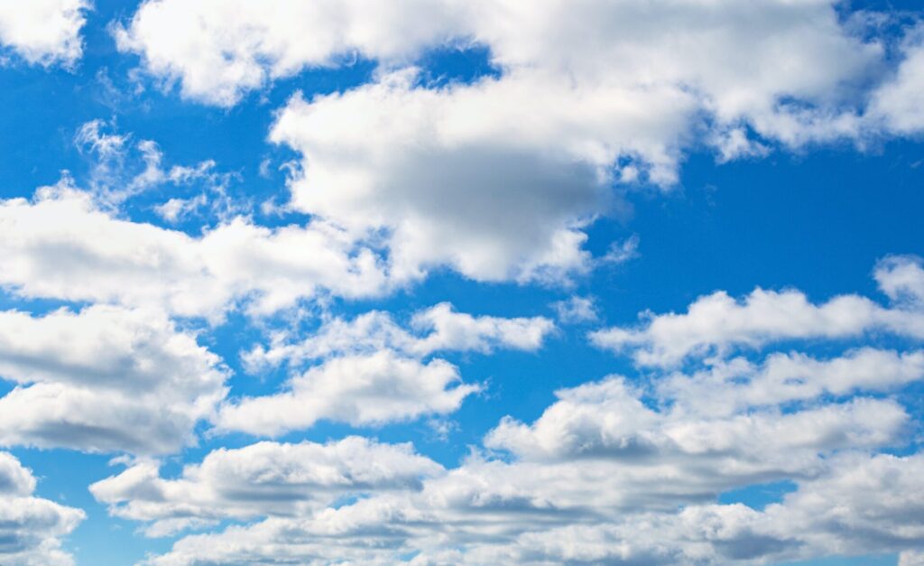 Clear blue sky background. White clouds on the sky